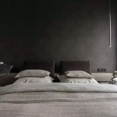 The wall behind the bed was lined with textile wallpaper