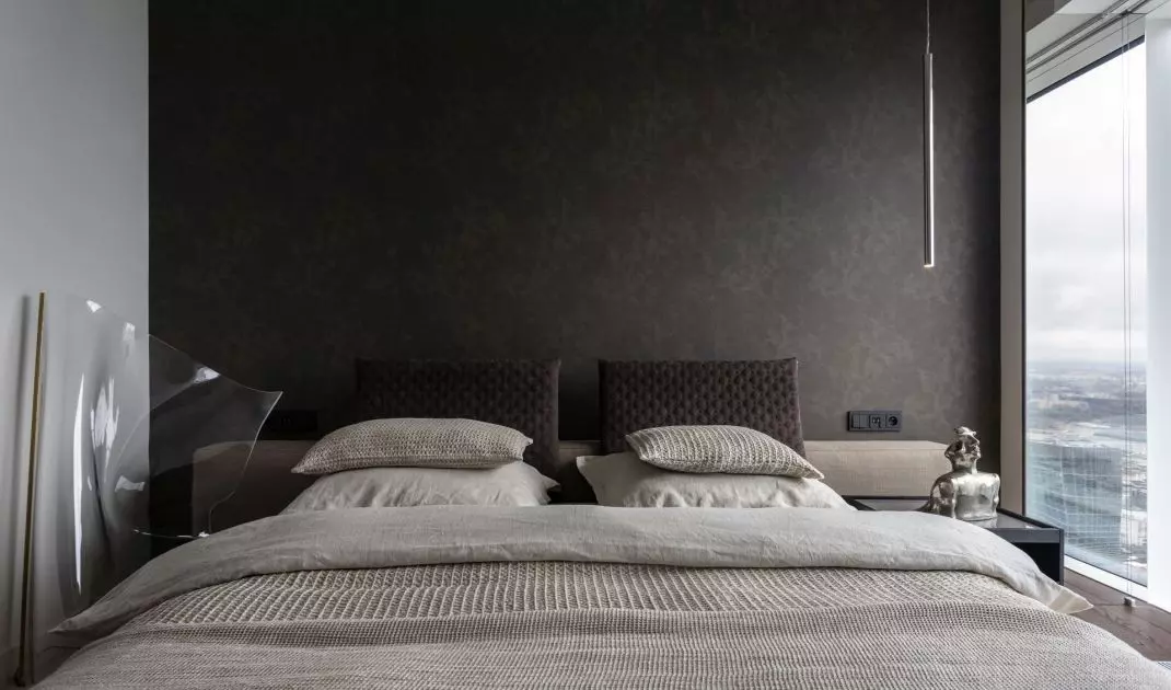 The wall behind the bed was lined with textile wallpaper