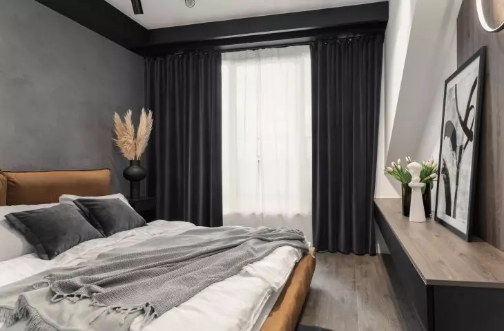 The bedroom is located in the attic. So the architect used thick dark curtains to protect from harsh light