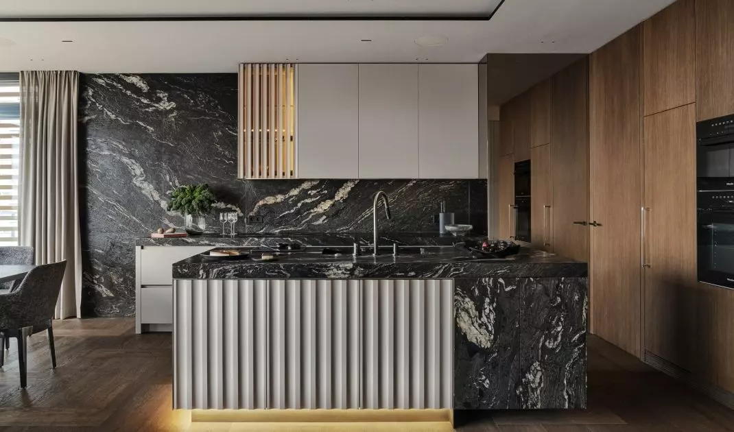 Brushed granite has been juxtaposed with smooth built-ins