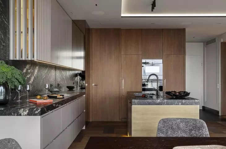 A pantry hides behind the veneered cabinetry