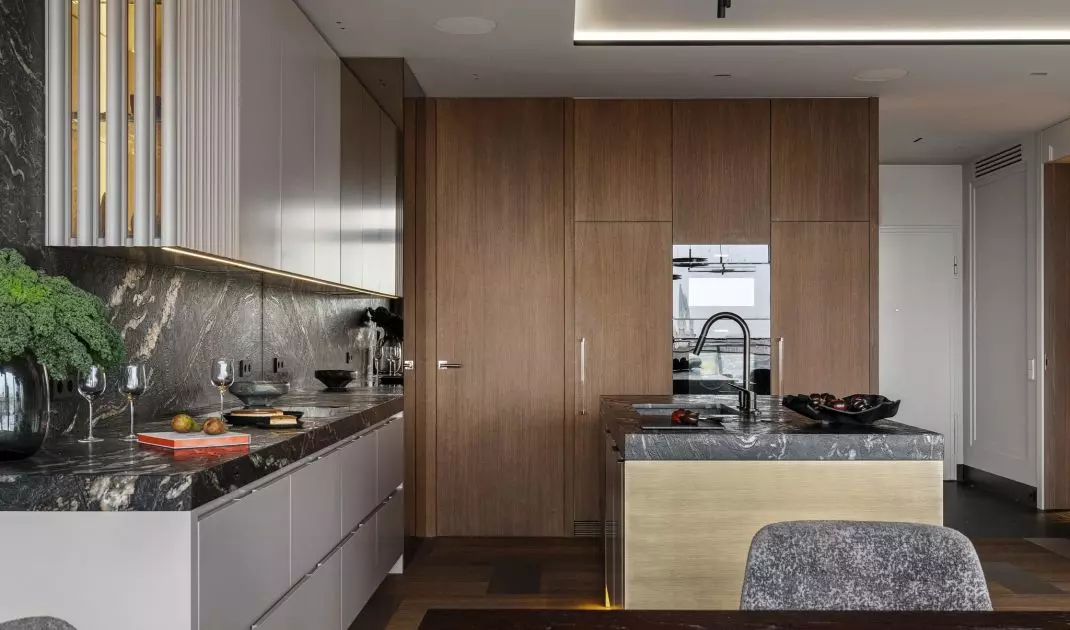 A pantry hides behind the veneered cabinetry