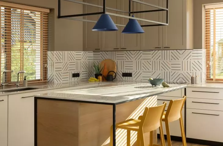 Cobalt lamps hang over the island