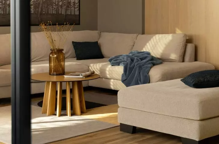 A sliding door with glazed wings in a wooden frame leads to the living room
