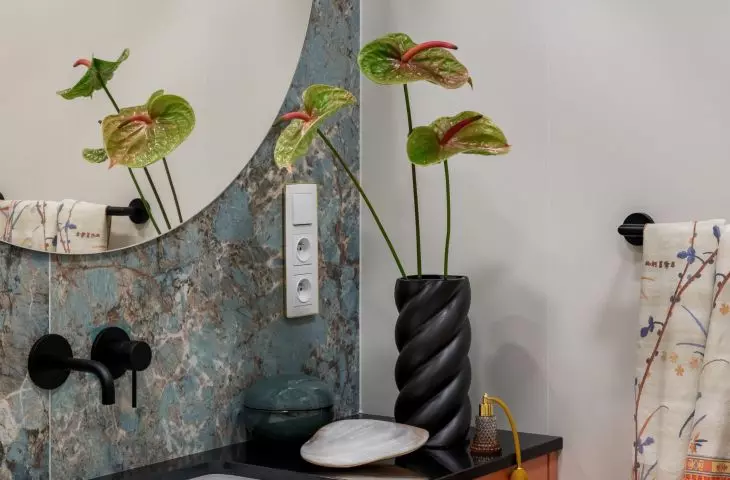 Green tiles create a soft background for orange furnishings