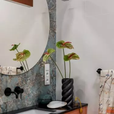 Green tiles create a soft background for orange furnishings