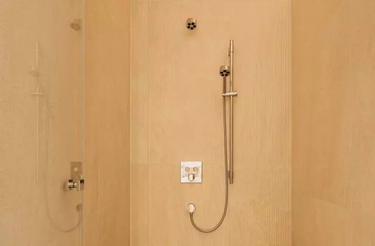 In addition to wood, the bathroom design also includes natural stone