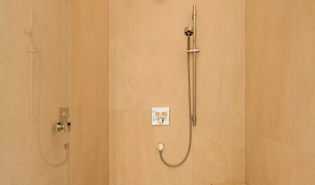 In addition to wood, the bathroom design also includes natural stone