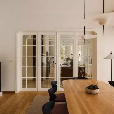 Between the kitchen and the dining room, the designers used decorative doors