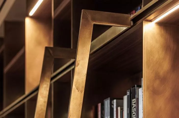 The bookcase was created from walnut wood and brushed brass