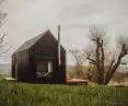 The cottage is planned on a rectangular plan and topped with a gable roof