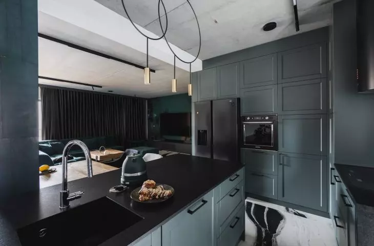 The kitchen is kept in dark colors
