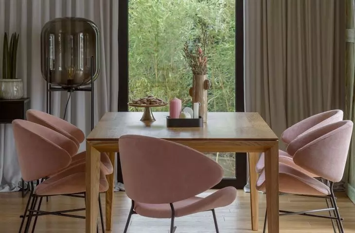 The large table is complemented by upholstered chairs