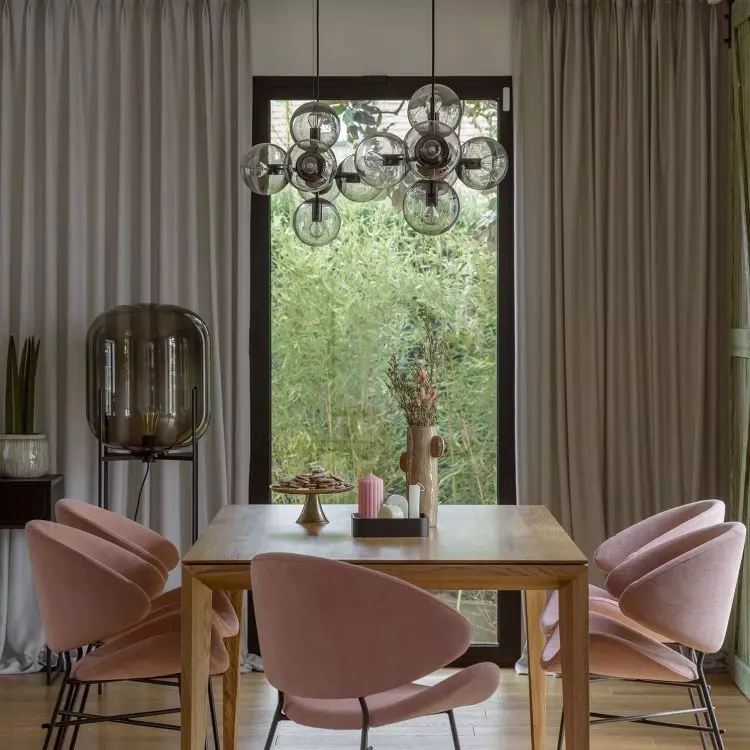 The large table is complemented by upholstered chairs