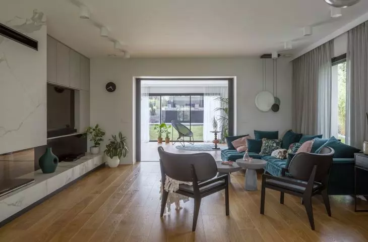 A blue sofa adds character to the seating area