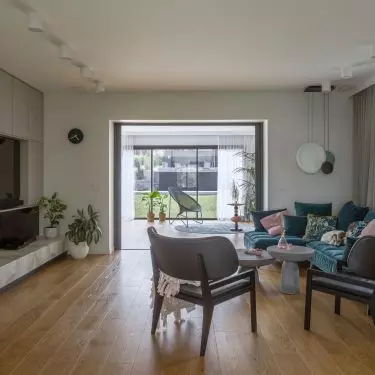 A blue sofa adds character to the seating area