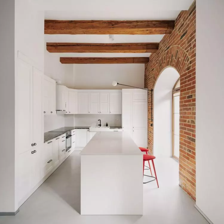 Red stools in a white kitchen will create an interesting contrast