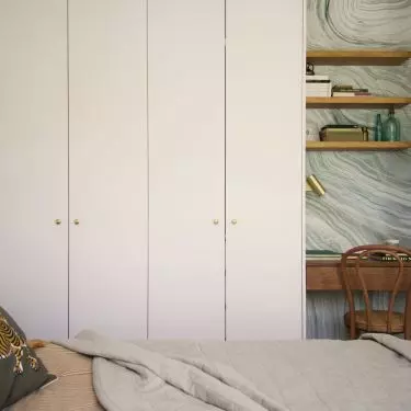 Alcove with desk stands out against neutral bedroom