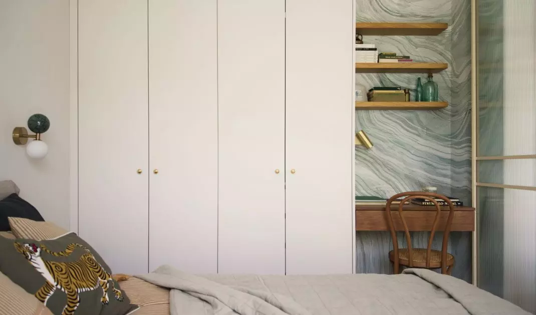 Alcove with desk stands out against neutral bedroom