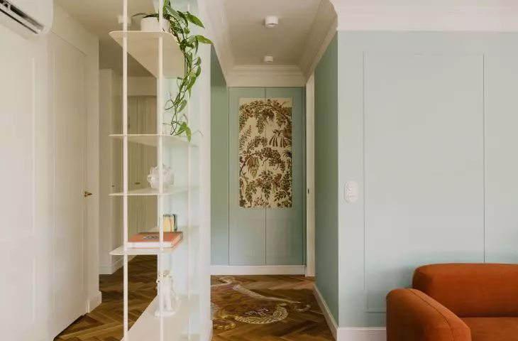 The front of the closet in the hallway is covered with decorative wallpaper