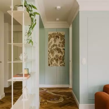 The front of the closet in the hallway is covered with decorative wallpaper