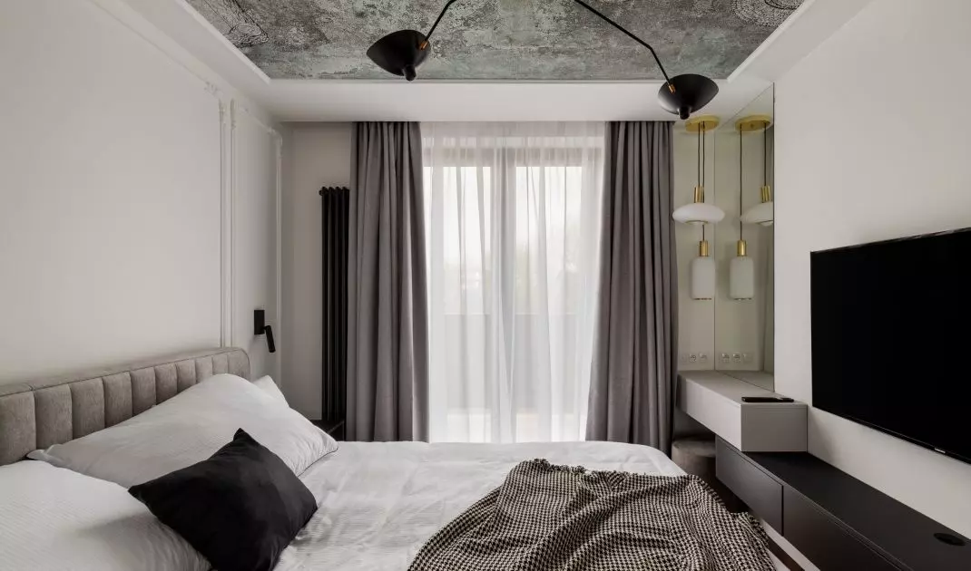 The bedroom decor is subdued