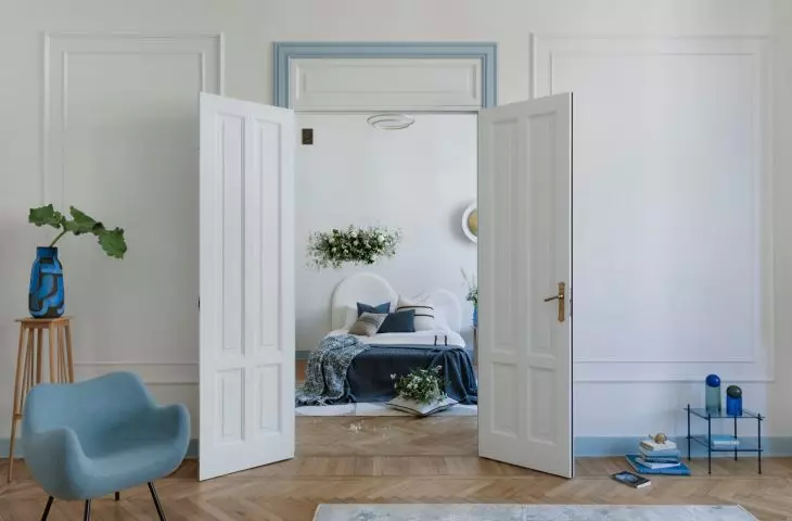 A tall double-sided door leads to the bedroom