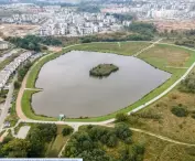 Swietokrzyska reservoir in the Southern Park in Gdansk, Poland. In the background, chaotic buildings 