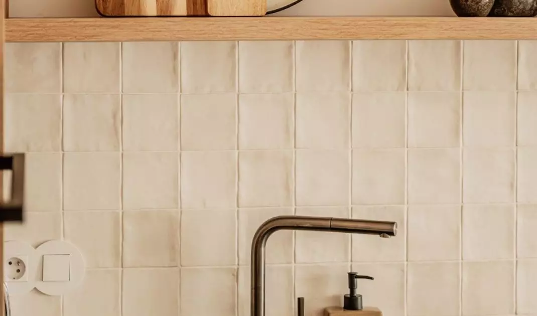 The space above the countertop was covered with zellige type tiles