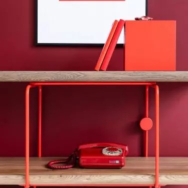 A simple bookcase with metal elements will bring a bauhaus vibe to the interior