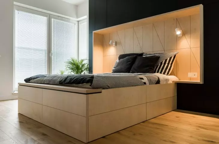 The headboard of the bed also functions as a closet