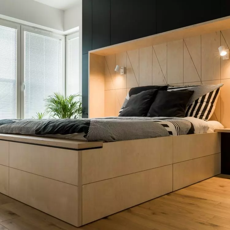 The headboard of the bed also functions as a closet