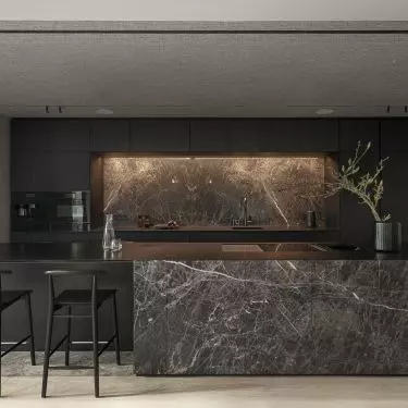 The island was equipped with a bar and a cooktop