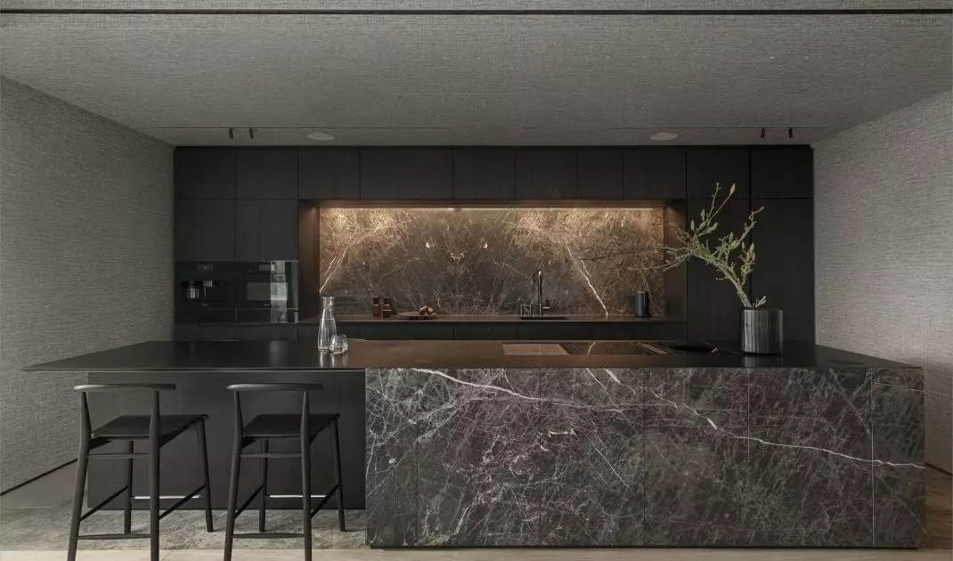 The island was equipped with a bar and a cooktop