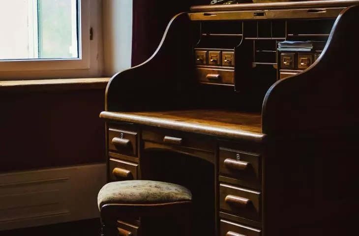A vintage-style desk can be the centerpiece of a Dark Academia arrangement