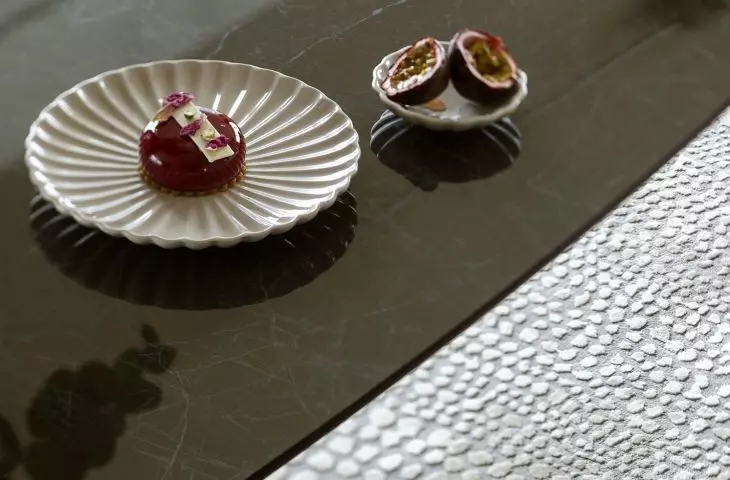The dark table is complemented by velour chairs