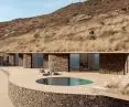 A veranda with a circular pool mimics the effect of flowing water, bringing movement and lightness to the outdoor space of Villa Rhoēs