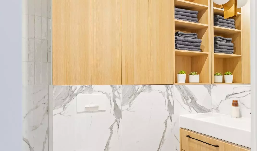 The wooden enclosure above the toilet also has open shelves
