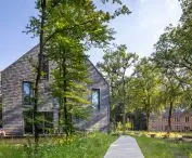 Two modern renovated buildings surrounded by forest with a terrace ideal for spending time outdoors