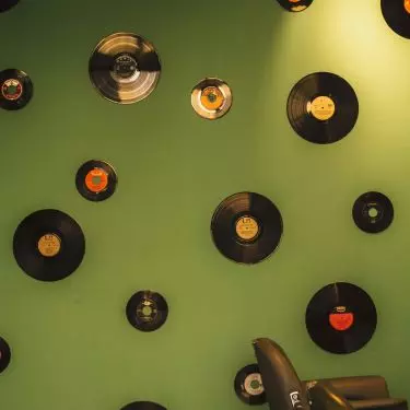 A composition of a variety of vinyl records will be an interesting wall decoration