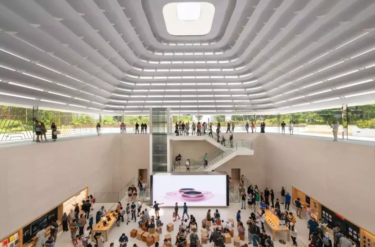 A sculptural quartz and glass staircase and a glass elevator connect different levels, and landings create multiple sightlines in Apple's The Exchange TRX space.