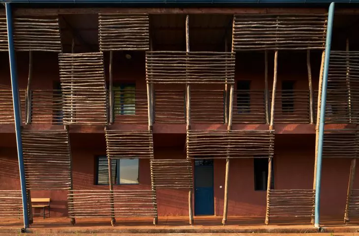 Building facade with wooden slats and blue window frames