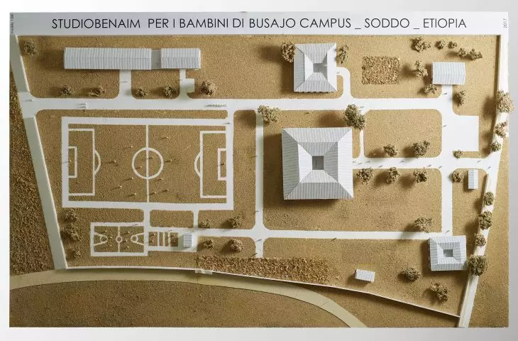 Architectural model of the campus with buildings with pyramid roofs and a soccer field