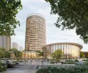 The 23-story tower, inspired by the shape of a dartboard, will offer hotel rooms and apartments for athletes