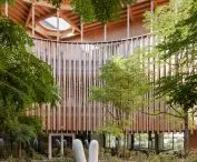Garden with abstract sculpture inside modern wooden building