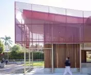 The façade of the pavilion in Hurlstone Park is covered with perforated red sheet metal, giving it a lightweight look