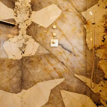Intriguing quartzite fluting adds a luxurious touch to the space