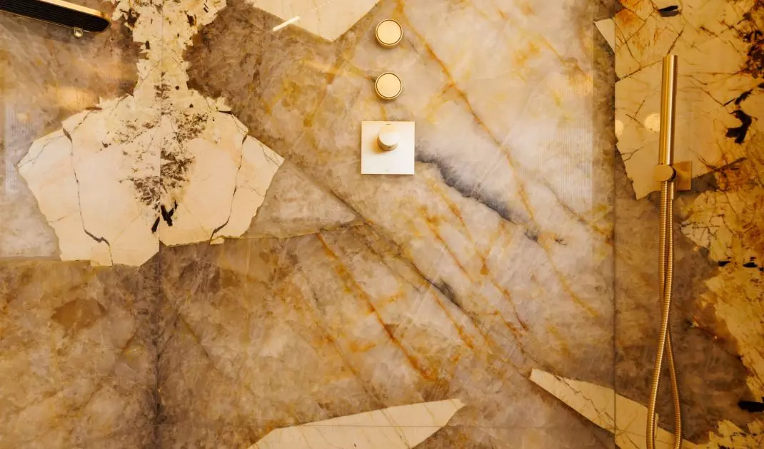Intriguing quartzite fluting adds a luxurious touch to the space