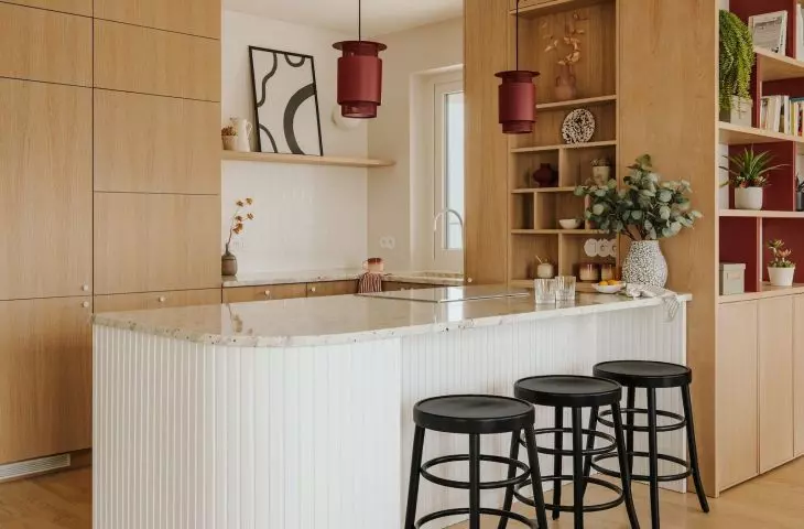 Kitchen with maroon accents designed by Angelika Fedorczuk