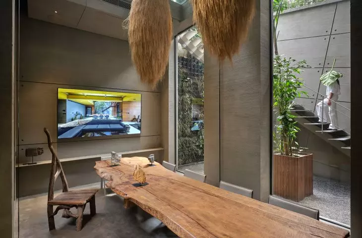Modern interior with rustic wooden table and wall-mounted TV